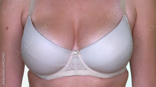 Closeup of a womans chest wich is wearing white lingerie. photo