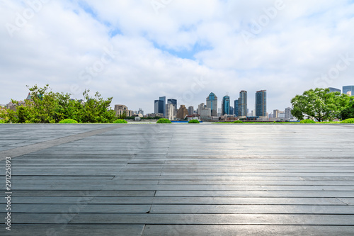 Shanghai skyline and empty wooden board square in city park