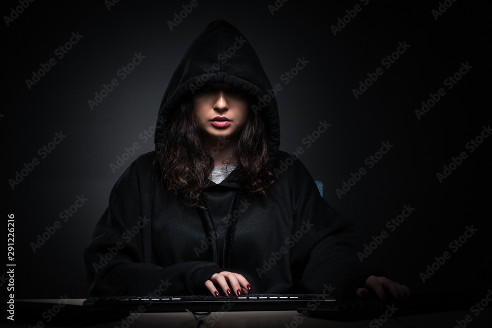 Female hacker hacking security firewall late in office Female hacker hacking security firewall late in office