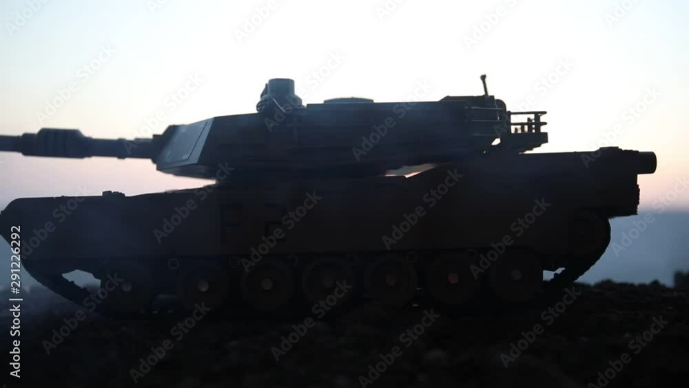 War Concept. Armored vehicle silhouette fighting scene on war fog sky background. American tank at sunset. Creative decoration War Concept. Armored vehicle silhouette fighting scene on war fog sky background. American tank at sunset. Creative decoration