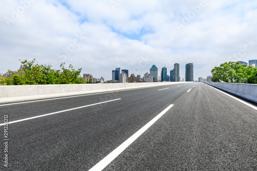 Empty asphalt highway and city skyline with buildings in Shanghai China.