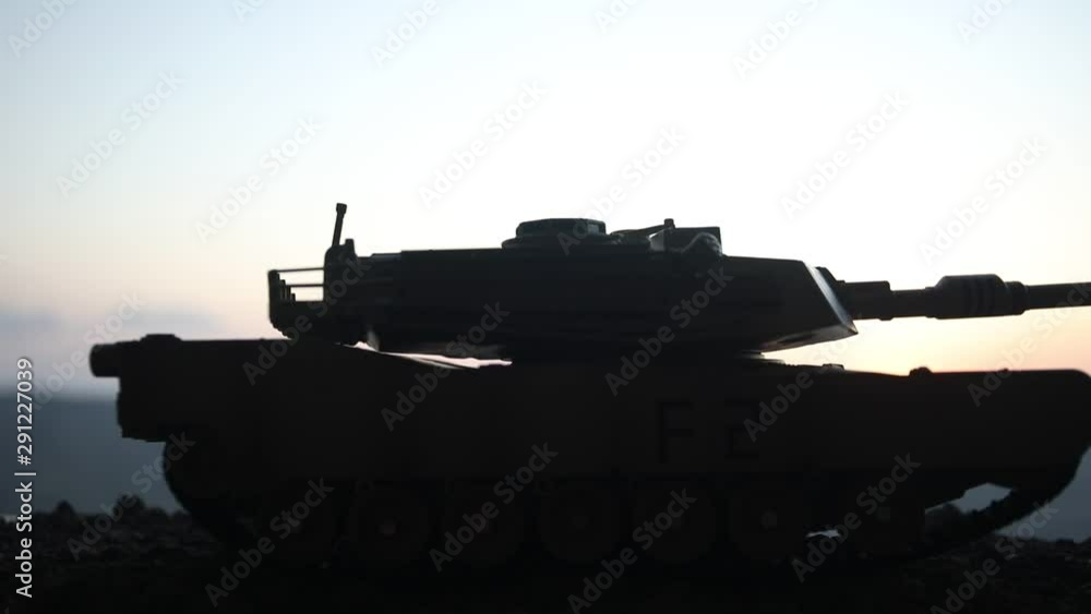 War Concept. Armored vehicle silhouette fighting scene on war fog sky background. American tank at sunset. Creative decoration War Concept. Armored vehicle silhouette fighting scene on war fog sky background. American tank at sunset. Creative decoration
