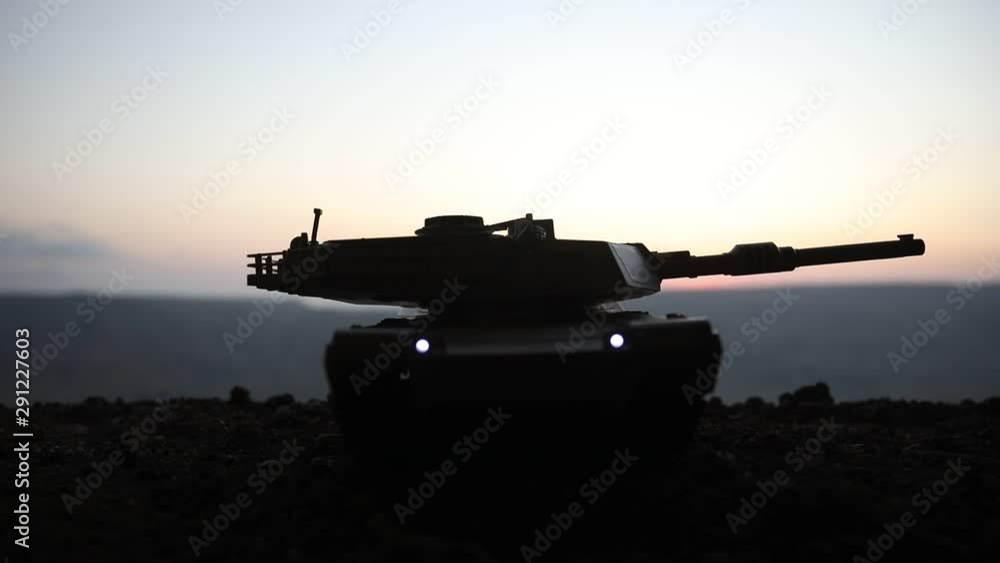 War Concept. Armored vehicle silhouette fighting scene on war fog sky background. American tank at sunset. Creative decoration War Concept. Armored vehicle silhouette fighting scene on war fog sky background. American tank at sunset. Creative decoration