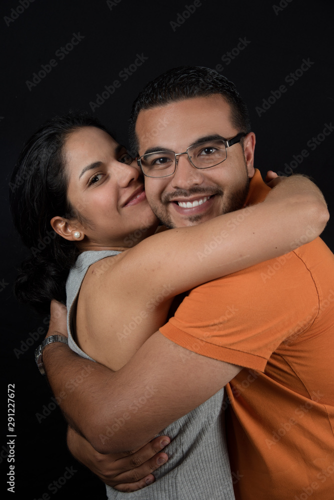Happy couple hugging and smiling. Happy couple. loving couple, only you and me. Black background Happy couple hugging and smiling. Happy couple. loving couple, only you and me. Black background