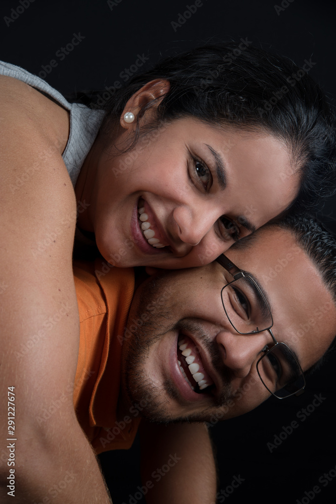 Happy and smiling couple in a warm embrace. Happy couple. loving couple, only you and me. Black background Happy and smiling couple in a warm embrace. Happy couple. loving couple, only you and me. Black background