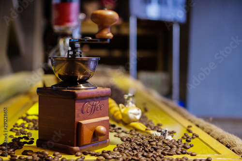Fototapeta Naklejka Na Ścianę i Meble -  Vintage manual coffee grinder and roasted coffee beans on yellow table