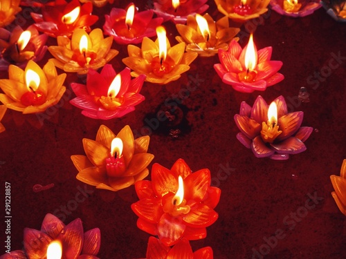 Candle in lotus design with fire float on the hot oil sink, .Floating flower candles in water for make merit in the Buddhist.