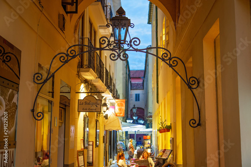 Malaga, Spain-May 16, 2019: people sitting in restaurants and enjoying national food in Malaga historic city center