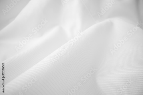 Shiny flowing cloth texture in macro shot. Wavy clean silk weave material. Textile abstract background. photo