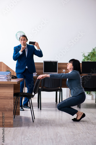 Two employees doing sport exercises in the office