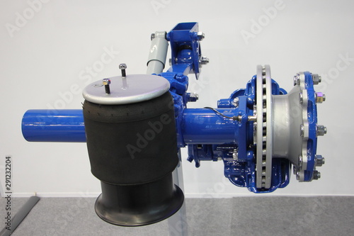 New truck semi trailer axle with air suspension and disk brake hub close up, heavy vehicle maintenance service photo