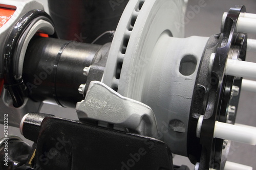 Disk brake truck trailer axle close up, heavy vehicle maintenance service