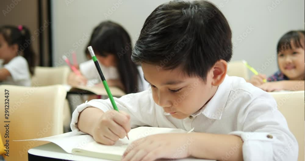 Asian children study and writing the classroom at school together. Concept of education. Asian children study and writing the classroom at school together. Concept of education.