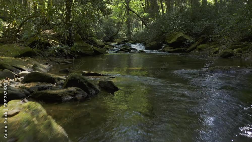 A low flight over a mountain stream toward a small cascade. A low flight over a mountain stream toward a small cascade.