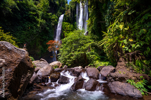 A traveller atand on the rock in Sekumpul waterfall photo