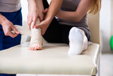 Leg injured woman visiting young doctor traumatologist