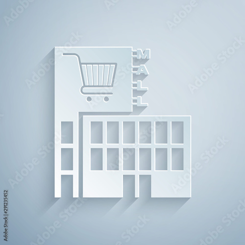 Paper cut Mall or supermarket building with shopping cart icon isolated on grey background. Shop or store. Paper art style. Vector Illustration