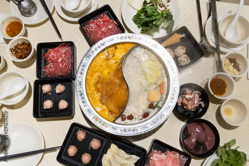 Quadro em tela Chinese steamboat with two soup variety accompanied with various ingredients