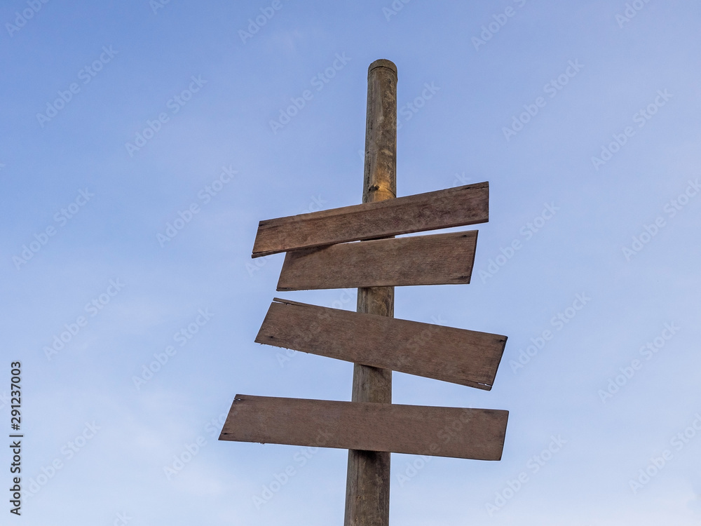 Four Wooden blanks sign stick in the bamboo have blue sky in the background.have space for put text.The symbol blank has brown colour. Four Wooden blanks sign stick in the bamboo have blue sky in the background.have space for put text.The symbol blank has brown colour.