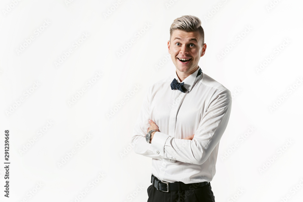 Portrait of young smiling handsome showman in white shirt with bowtie, studio shot isolated on white background. Businessman Portrait of young smiling handsome showman in white shirt with bowtie, studio shot isolated on white background. Businessman