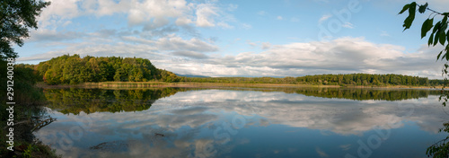 Fototapeta Naklejka Na Ścianę i Meble -  Beautiful panorama of autumn lake against the background of forest and sunny sky