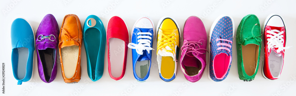 A lot of colored youth women's shoes without heels. Sneakers, slippers, ballet shoes. White background. - obrazy, fototapety, plakaty 