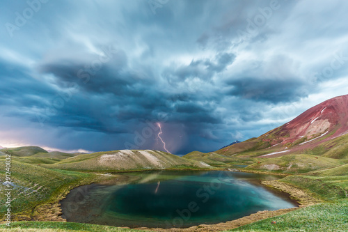 View of Tulpar Kul lake in Kyrgyzstan during the storm photo