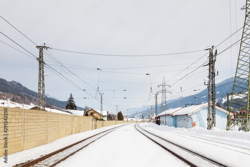 The view along a snow covered railway track from Bruck - Fusch Station in the state of Salzburg, Austria. Bruck and Fusch are both municipalities in Zell am See district. The view along a snow covered railway track from Bruck - Fusch Station in the state of Salzburg, Austria. Bruck and Fusch are both municipalities in Zell am See district.