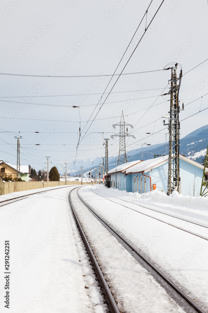 The view along a snow covered railway track from Bruck - Fusch Station in the state of Salzburg, Austria. Bruck and Fusch are both municipalities in Zell am See district. The view along a snow covered railway track from Bruck - Fusch Station in the state of Salzburg, Austria. Bruck and Fusch are both municipalities in Zell am See district.