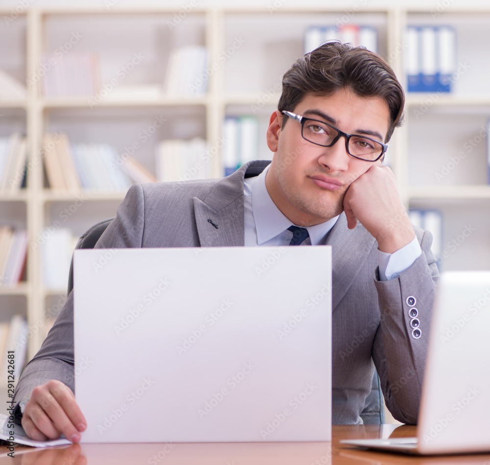 Businessman in office holding a blank message board Businessman in office holding a blank message board