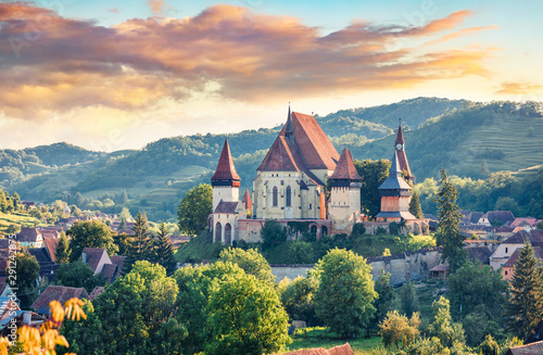 Splendid summer view of Fortified Church of Biertan, UNESCO World Heritage Sites since 1993. Colorful morning cityscape of Biertan town, Transylvania, Romania, Europe. Traveling concept background. photo