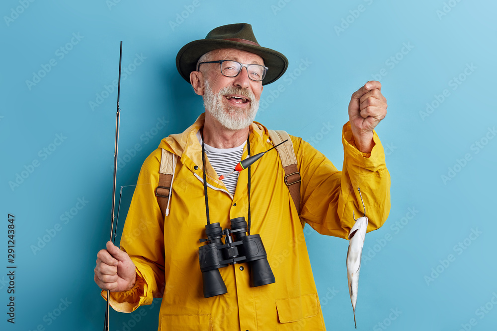 old granny in glasses having glad expression, close up photo. isolated blue background, studio shot old granny in glasses having glad expression, close up photo. isolated blue background, studio shot