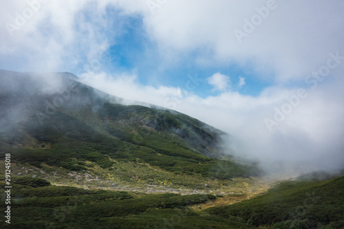Mt. Norikura wrapped in clouds in Nagano, Japan © studio_s