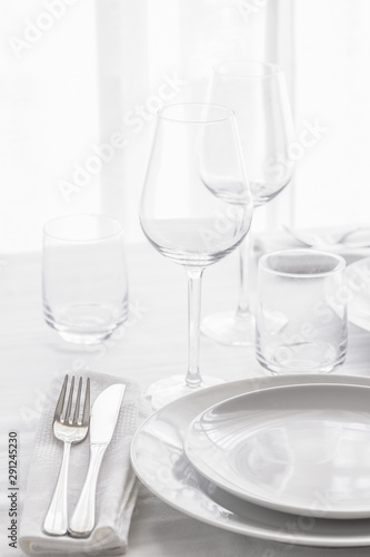 Table set with silver cutlery and glassware . Dinning concept background. Close up.