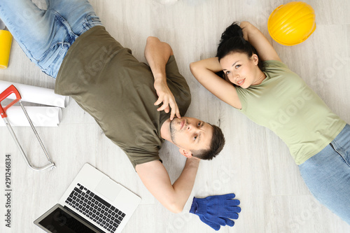 Happy couple planning desig...