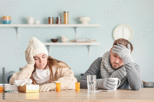 Sick couple sitting at kitc...