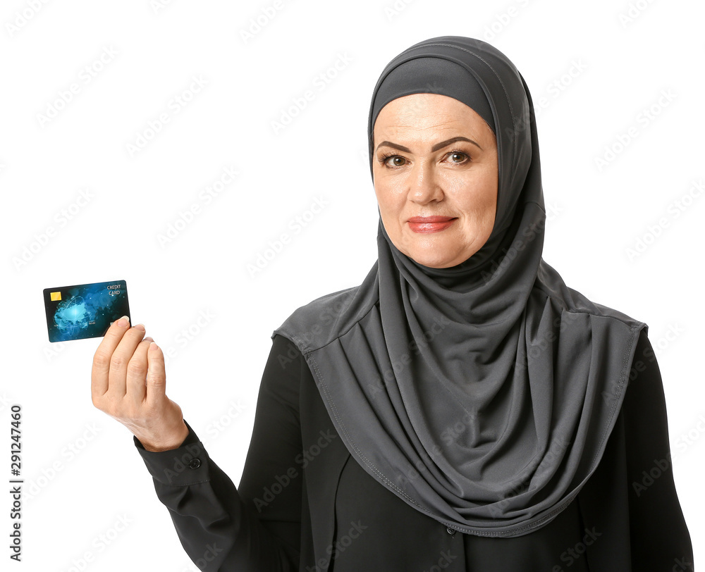 Beautiful mature Muslim woman with credit card on white background Beautiful mature Muslim woman with credit card on white background