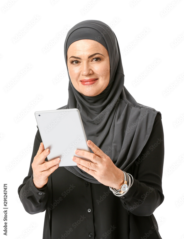 Beautiful mature Muslim woman with tablet computer on white background Beautiful mature Muslim woman with tablet computer on white background