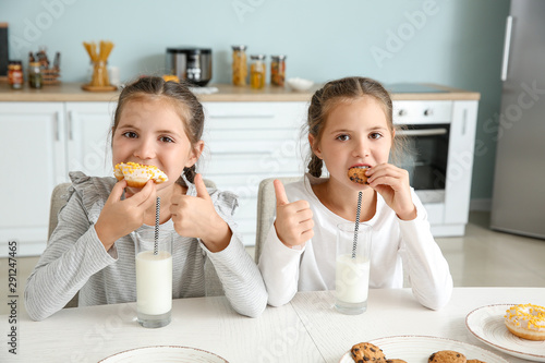 Portrait of cute twin girls...