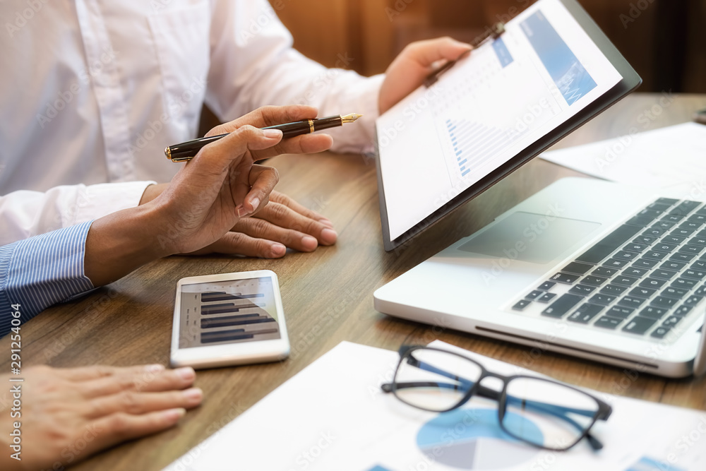 Business team brainstorming and discussing with financial data and report graph. Teamwork meeting working concept. Business team brainstorming and discussing with financial data and report graph. Teamwork meeting working concept.