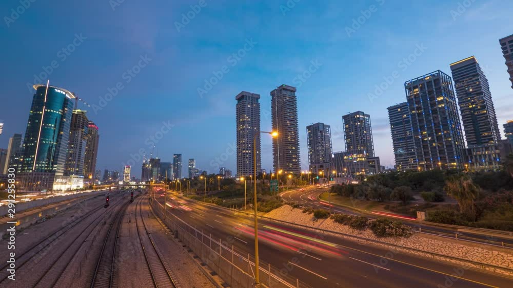 A gorgeous timelapse of road traffic taken in the evening. Orange lights on the streets, tall buildings (skyscrapers) over a blue sky getting darker. A gorgeous timelapse of road traffic taken in the evening. Orange lights on the streets, tall buildings (skyscrapers) over a blue sky getting darker.