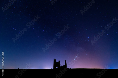 Night photography of the Castle in Ruins of Caudilla (Toledo - Spain), with the milky way and a shooting star.