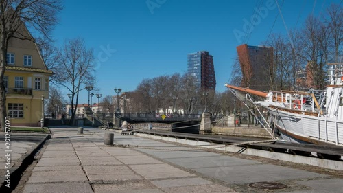 Timelapse of people and transport rush across Birzos tiltas Exchange bridge over Dane river in Klaipeda, Lithuania photo