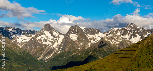 A stunning telephoto shot of the mountains Hochschober, Garnot and Gloedis of the Schober mountain range in the Austrian Alps, shot on a beautiful summer evening from a nearby mountain top.