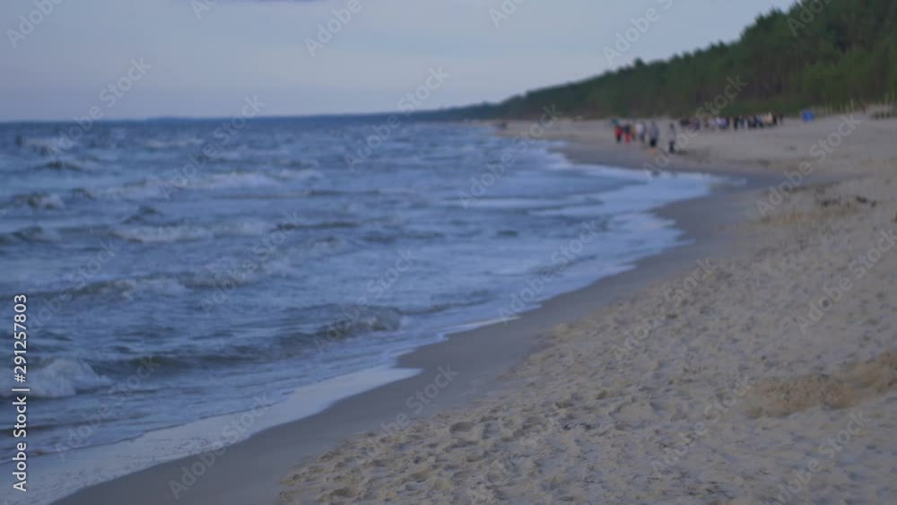 People relaxing on the beach of Baltic Sea at sunset. People relaxing on the beach of Baltic Sea at sunset.