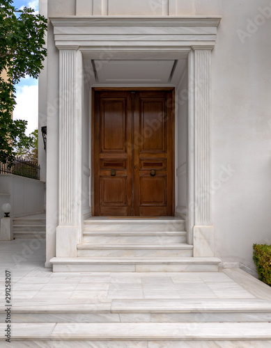 contemporary elegant house entrance solid wood door and white marble walls