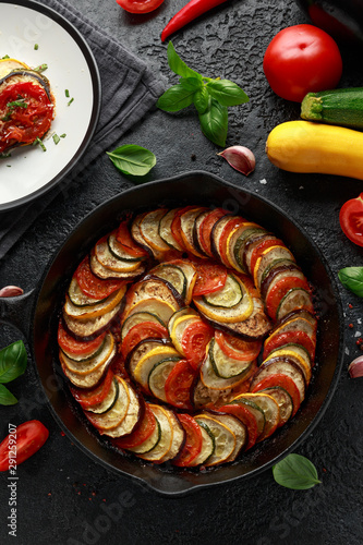 Ratatouille Vegetable Stew with zucchini, eggplants, tomatoes, garlic, onion and basil. on cast iron pan. Traditional French food. photo