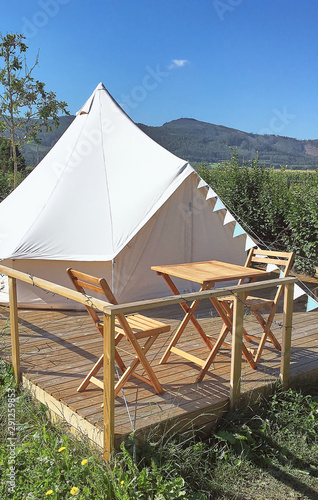 Glamping / Camping tent with wood chairs and table