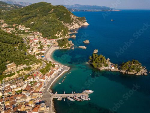 Parga Greece drone aerial view. Crystal water natural landscape and beautiful architectural buildings near the port of Parga Epirus, Greece, Europe.