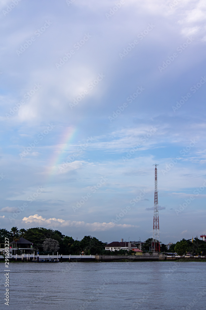 Rainbow on the Chao Phraya River with signal towers Rainbow on the Chao Phraya River with signal towers